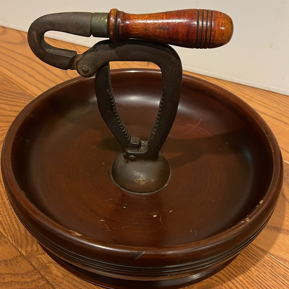 Vintage nut cracker attached to wooden bowl